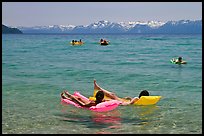 Children playing in water, and distant snowy mountains, Sand Harbor, Lake Tahoe, Nevada. USA (color)