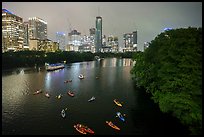 Skyline and kayaks on Colorado River at night. Austin, Texas, USA ( color)