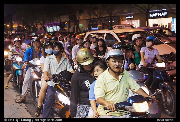 Riders waiting for traffic light at night. Ho Chi Minh City, Vietnam