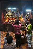 Women offering incense to Jade Emperor figure, Phuoc Hai Tu pagoda, district 3. Ho Chi Minh City, Vietnam (color)