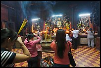 Worshipping at altar with  Jade Emperor and Four Big Diamonds, Chua Ngoc Hoang, district 3. Ho Chi Minh City, Vietnam (color)