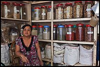 Woman with jars of traditional medicinal supplies. Cholon, Ho Chi Minh City, Vietnam (color)
