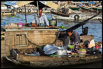 Woman serving food across boats, Cai Rang floating market. Can Tho, Vietnam (color)