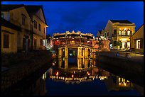 Japanese covered bridge reflected in canal at night. Hoi An, Vietnam ( color)