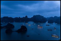 Tour boats lights and islands from above at night. Halong Bay, Vietnam (color)
