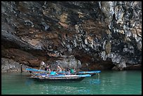 Fishermen anchor in cave for breakfast. Halong Bay, Vietnam (color)
