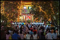 Worshippers at Quoc Tu Pagoda by night, district 10. Ho Chi Minh City, Vietnam (color)