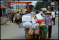 Woman pushing a bicycle loaded with cheap goods at the Lao Cai border crossing. Vietnam
