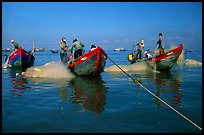 Fishermen get their nets out of their small fishing boats. Vung Tau, Vietnam (color)
