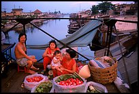 Family selling fruit on a bridge. Cholon, Ho Chi Minh City, Vietnam (color)