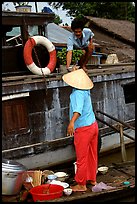 Passsing a bowl of pho from boat to boat. Can Tho, Vietnam (color)