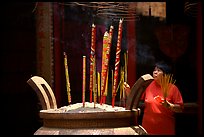 Offering incense at a Chinese temple in Cho Lon. Cholon, District 5, Ho Chi Minh City, Vietnam (color)