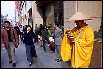Buddhist monk seeking alms in front of a Ginza department store. Tokyo, Japan (color)