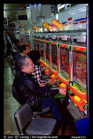 Playing a gambling maching. Tokyo, Japan (color)