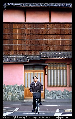 Bicyclist in front of a traditional style house. Kyoto, Japan (color)