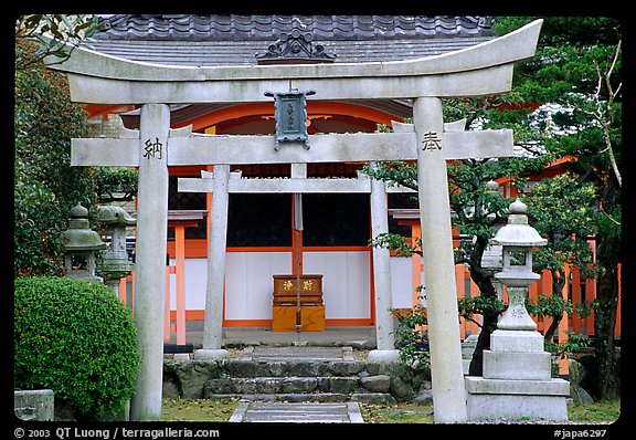 Tori gate at the entrance of a shrine inner grounds. The act of passing through purifies the soul.. Kyoto, Japan (color)