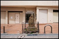 Stone monument on modern street. Fujisawa, Japan ( color)