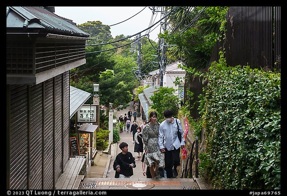 Couple on back street with restaurants. Enoshima Island, Japan (color)