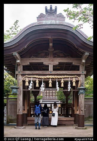 Women worshiping at Okutsumiya, the original shrine of the island. Enoshima Island, Japan (color)
