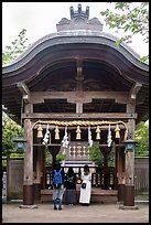 Women worshiping at Okutsumiya, the original shrine of the island. Enoshima Island, Japan ( color)