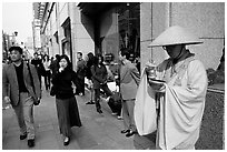 Buddhist monk seeking alms in front of a Ginza department store. Tokyo, Japan ( black and white)