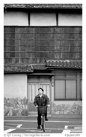 Bicyclist in front of a traditional style house. Kyoto, Japan (black and white)