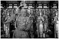 Some of the 1001 statues of the thousand-armed Kannon (buddhist goddess of mercy), Sanjusangen-do Temple. Kyoto, Japan ( black and white)