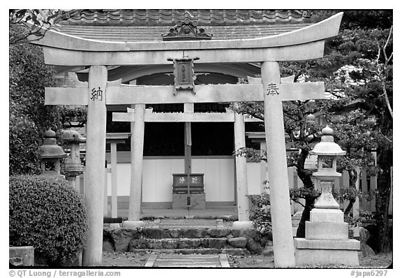 Tori gate at the entrance of a shrine inner grounds. The act of passing through purifies the soul.. Kyoto, Japan (black and white)
