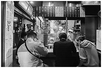 Tiny open restaurant serving noddles, Omoide Yokocho, Shinjuku. Tokyo, Japan ( black and white)