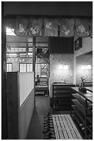 Restaurant entrance with slippers and shoe racks, Fujisawa. Japan ( black and white)