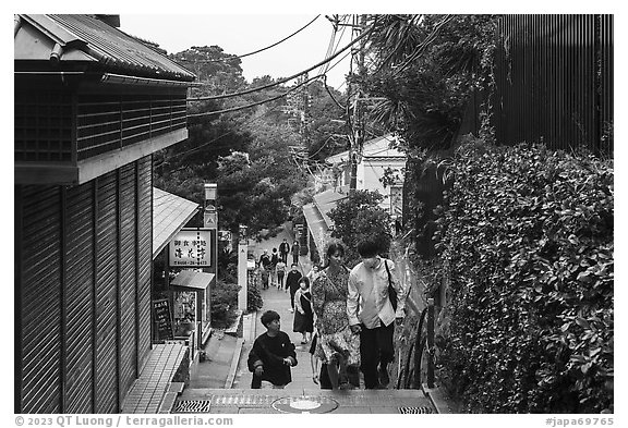 Couple on back street with restaurants. Enoshima Island, Japan (black and white)