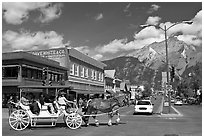 Horse carriage on Banff avenue. Banff National Park, Canadian Rockies, Alberta, Canada (black and white)