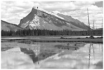 Canoe and Mt Rundle reflection in first Vermillion Lake, afternon. Banff National Park, Canadian Rockies, Alberta, Canada ( black and white)