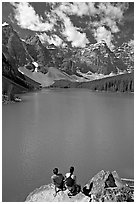 Couple sitting on the edge of Moraine Lake. Banff National Park, Canadian Rockies, Alberta, Canada ( black and white)
