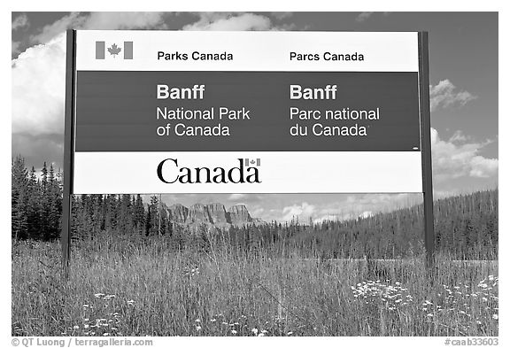 Bilingual sign at the entrance of the Park. Banff National Park, Canadian Rockies, Alberta, Canada (black and white)