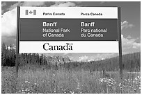 Bilingual sign at the entrance of the Park. Banff National Park, Canadian Rockies, Alberta, Canada (black and white)