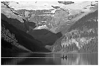 Rowers on Lake Louise, below Victoria Glacier, early morning. Banff National Park, Canadian Rockies, Alberta, Canada ( black and white)