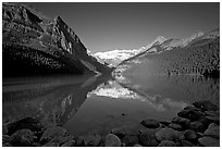 Mountains reflected in Lake Louise, early morning. Banff National Park, Canadian Rockies, Alberta, Canada (black and white)