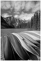 Colorful canoes stacked on the boat dock, Lake Moraine, morning. Banff National Park, Canadian Rockies, Alberta, Canada (black and white)