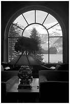 Lake Louise seen through a window of Chateau Lake Louise hotel. Banff National Park, Canadian Rockies, Alberta, Canada (black and white)