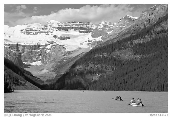 Canoes, Victoria Peak, and blue-green glacially colored Lake Louise, morning. Banff National Park, Canadian Rockies, Alberta, Canada