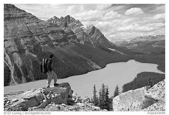 Hiker standing on a rock overlooking Peyto Lake. Banff National Park, Canadian Rockies, Alberta, Canada (black and white)