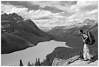 Hiker wearing backpack looking at Peyto Lake. Banff National Park, Canadian Rockies, Alberta, Canada (black and white)