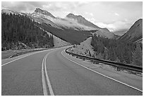 Twisting road, Icefields Parkway, sunset. Banff National Park, Canadian Rockies, Alberta, Canada (black and white)