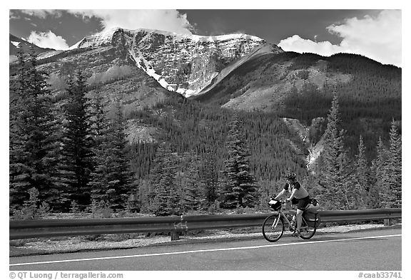 Woman cycling the Icefields Parkway. Jasper National Park, Canadian Rockies, Alberta, Canada