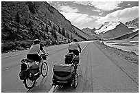 Couple cycling the Icefields Parkway. Jasper National Park, Canadian Rockies, Alberta, Canada ( black and white)