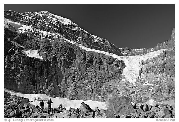 Hikers on a moraine below Mt Edith Cavell, morning. Jasper National Park, Canadian Rockies, Alberta, Canada (black and white)