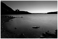 Boulders in Waterton Lake and Prince of Wales hotel, dawn. Waterton Lakes National Park, Alberta, Canada (black and white)