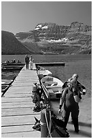 Couple preparing to scuba dive, Cameron Lake. Waterton Lakes National Park, Alberta, Canada ( black and white)