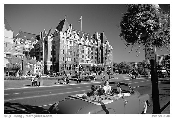 Red convertible car and Empress hotel. Victoria, British Columbia, Canada (black and white)